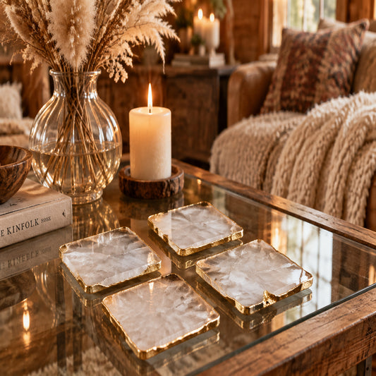 Square marble coasters with gold edges on a white surface